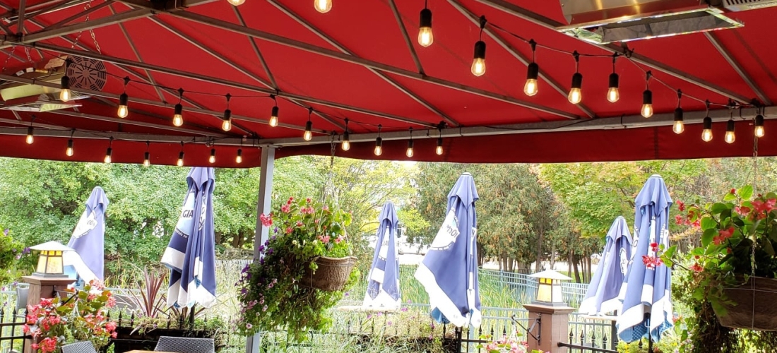 Red tent with outdoor lights over Moose Winooski's outdoor patio.